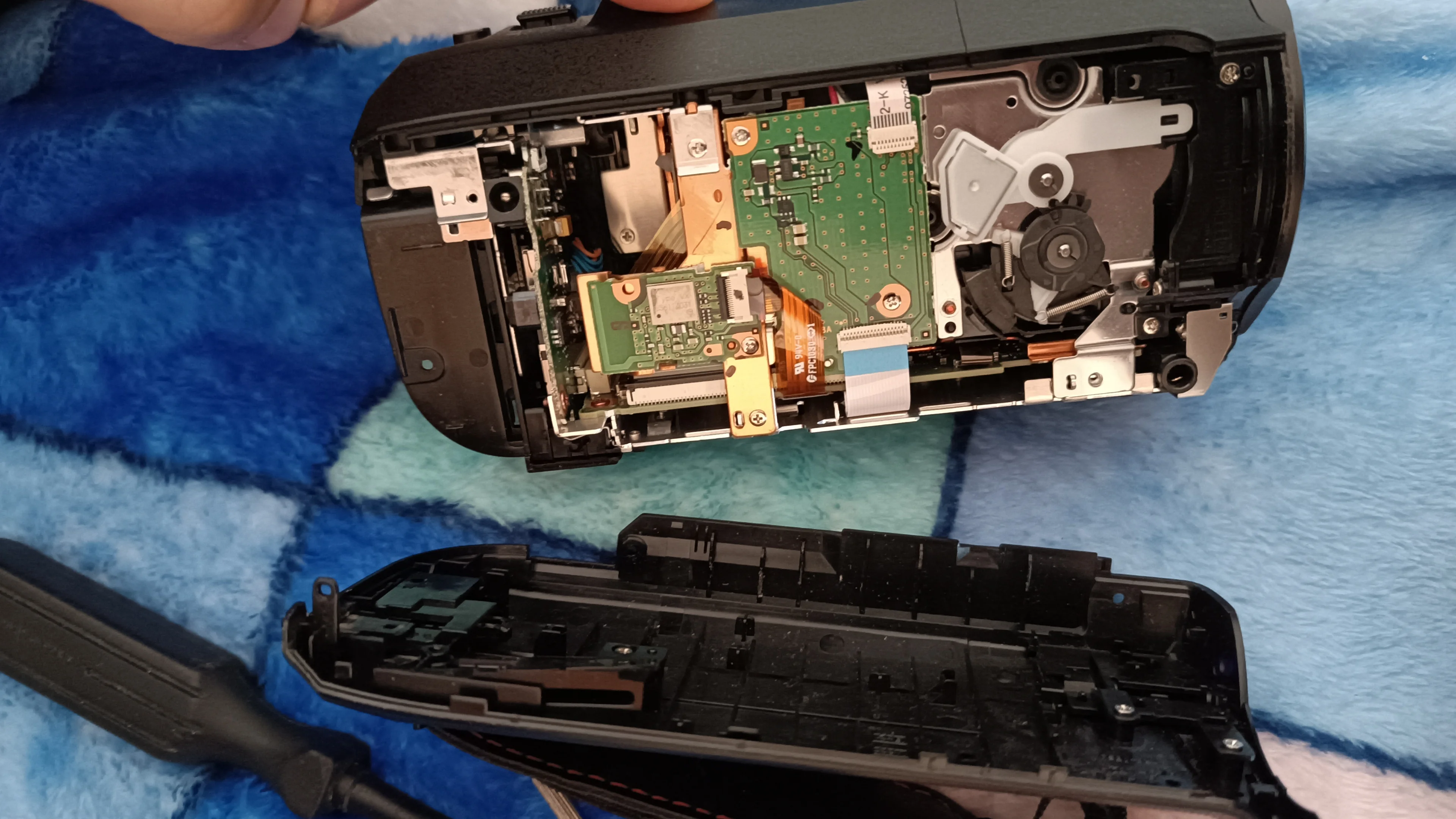 The first part that can be removed is the opposite cover where the charging plug is.