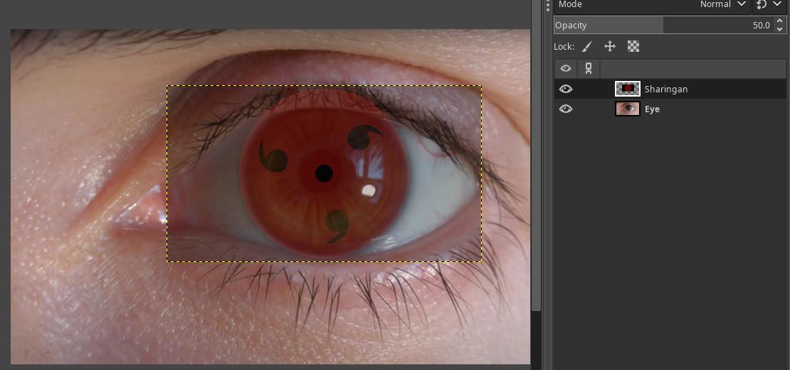 Now I need to scale and move the sharingan with the standard GIMP transformation tools and place it at the eye. I set the sharingan layer to half visibility to see both layers.