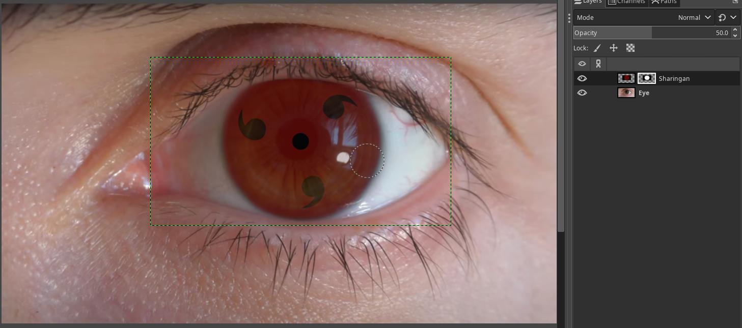 Right clicked the sharingan layer, selected Add Layer Mask set to white. Then selected the brush tool and drew black color to the parts where the sharingan should not be visible like the white part of the eye, eyelids, to remove the black background etc. I used the brush with feather to make the edges look more smooth. You can see that when I leave the opacity at 50%, the image already looks good.