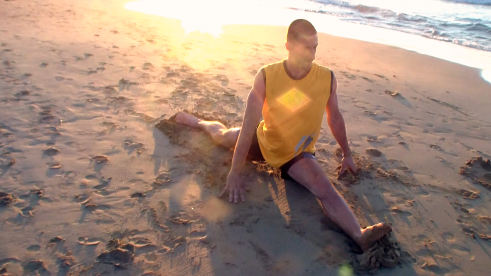 Gymnastic front split on a beach
