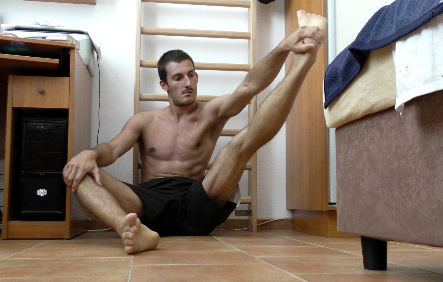Grabbing the foot and stretching from cross-legged